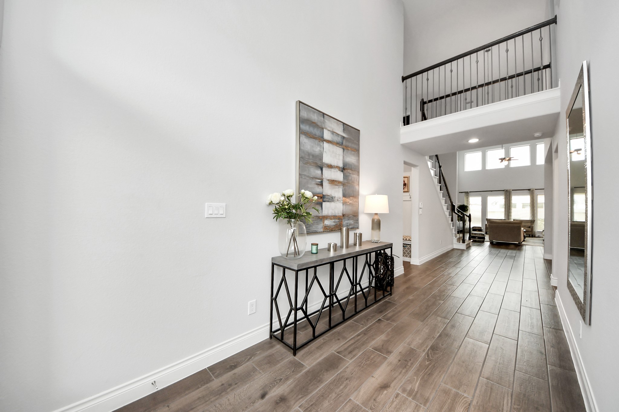 2242 Bayleaf Manor Drive Manvel, TX 77578 - Photo 13 of 48 a view of a hallway with wooden floor and staircase