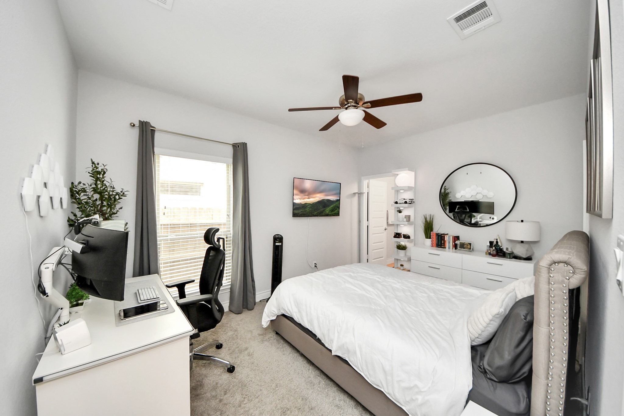 2242 Bayleaf Manor Drive Manvel, TX 77578 - Photo 14 of 48 a bedroom with a bed and a chandelier