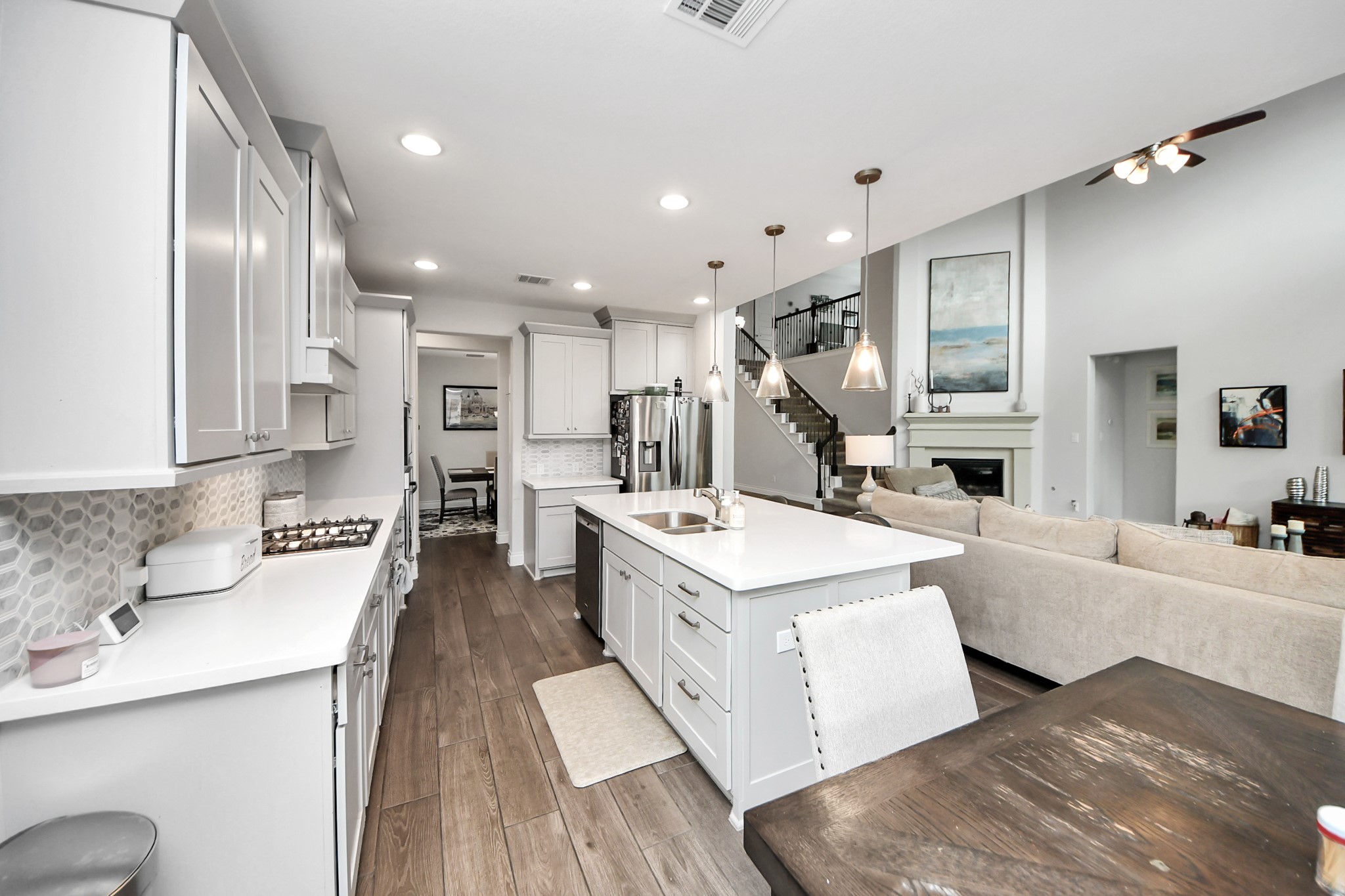 2242 Bayleaf Manor Drive Manvel, TX 77578 - Photo 2 of 48 a large white kitchen with a large counter top appliances and cabinets