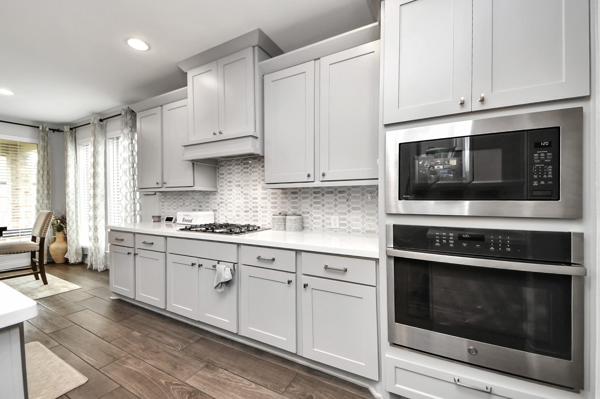 2242 Bayleaf Manor Drive Manvel, TX 77578 - Photo 21 of 50 a kitchen with stainless steel appliances granite countertop a stove microwave and cabinets