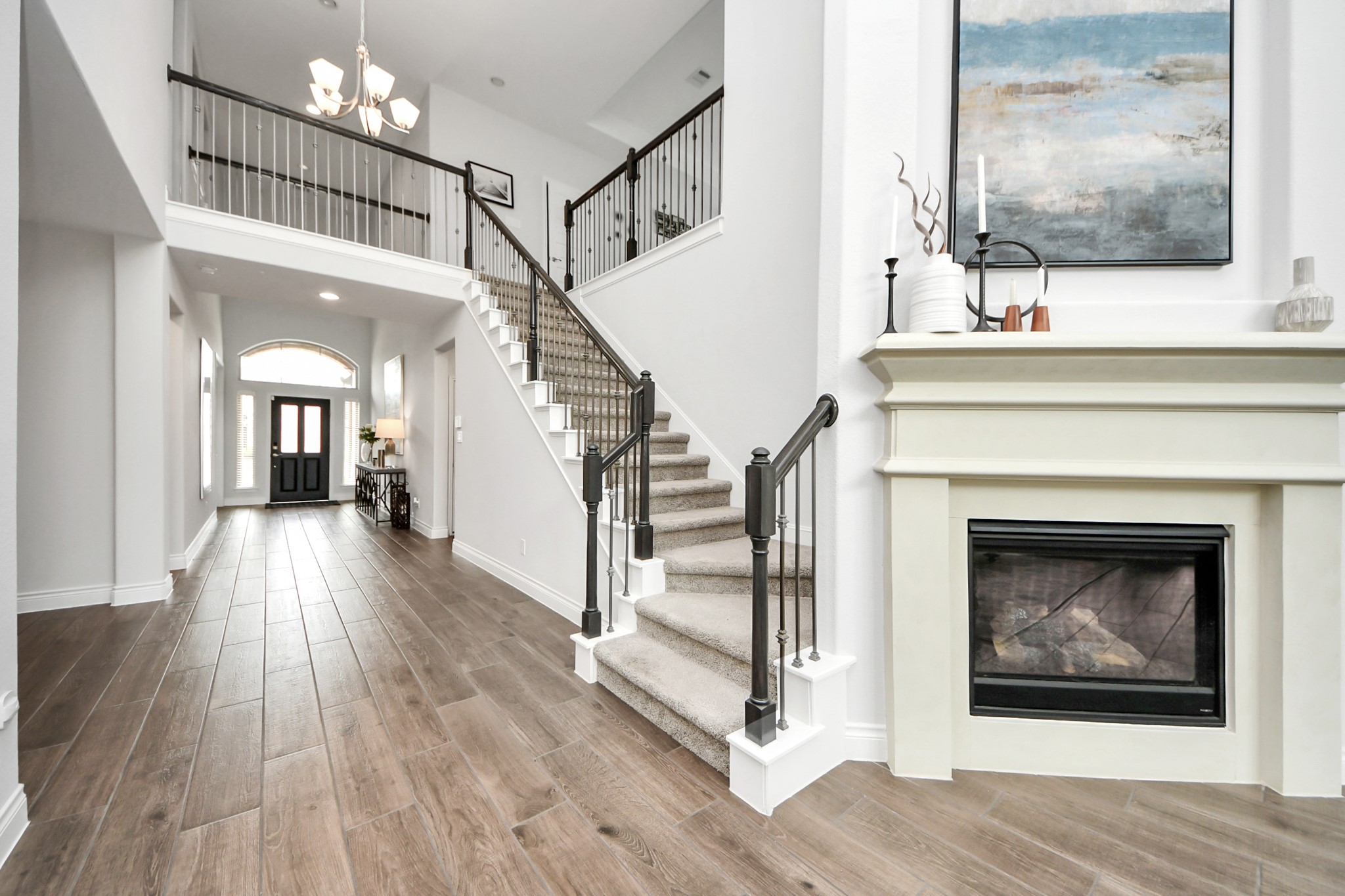 2242 Bayleaf Manor Drive Manvel, TX 77578 - Photo 33 of 50 a view of a hallway with wooden floor and a fireplace