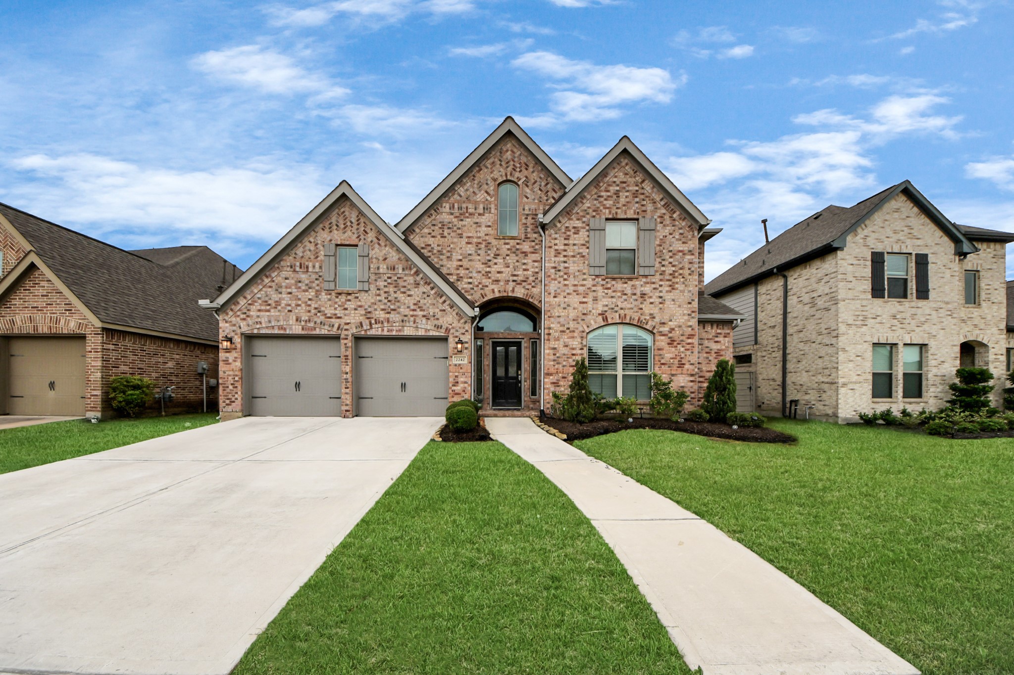 2242 Bayleaf Manor Drive Manvel, TX 77578 - Photo 6 of 50 a front view of a house with a yard and garage