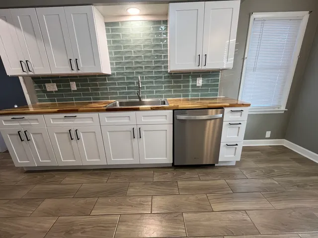 a kitchen with a refrigerator stove and microwave