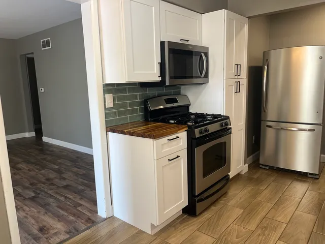 a kitchen with a refrigerator stove and microwave
