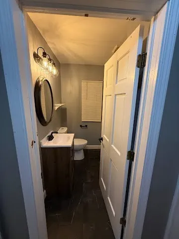 a view of a bathroom with a sink and mirror with bathtub
