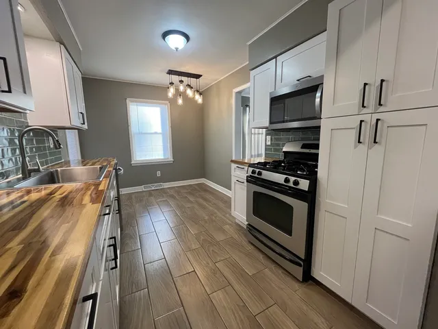 a kitchen with granite countertop a stove and a refrigerator