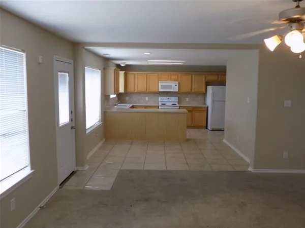 a room with a large window and a fireplace