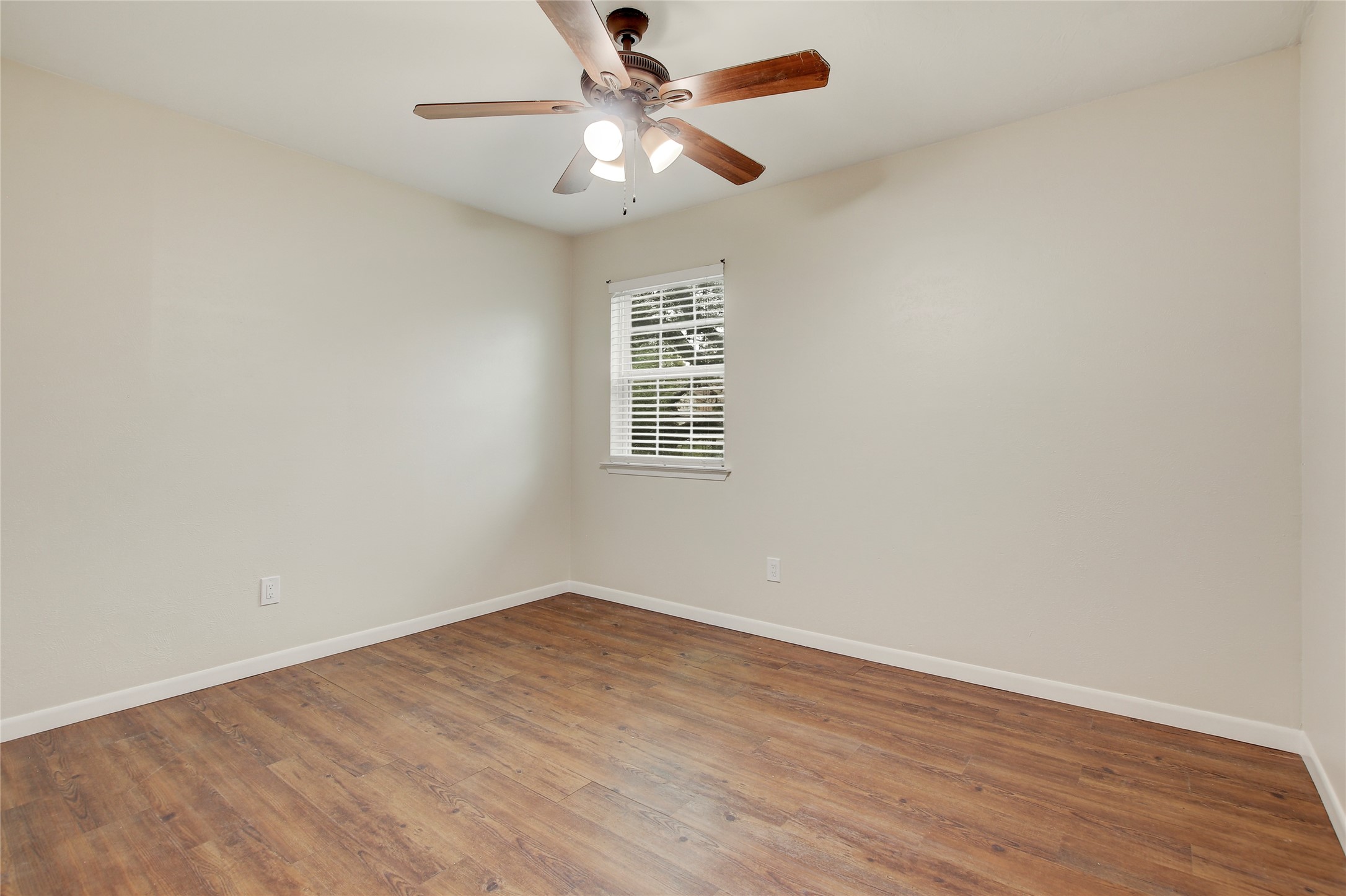 6902 Rifle Bend, Unit B Austin, TX 78736 - Photo 14 of 34 wooden floor in an empty room with a window