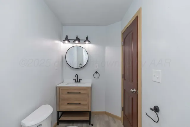 a bathroom with a toilet a sink and a mirror