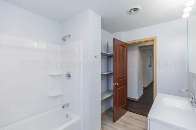 a bathroom with a bathtub and a sink