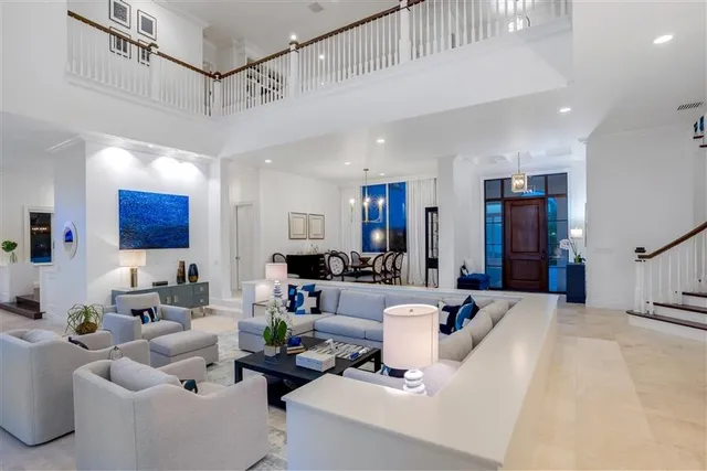 a kitchen with stainless steel appliances kitchen island granite countertop furniture wooden floor and a view of living room