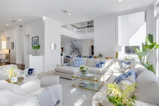 a spacious bedroom with a large bed and a large window