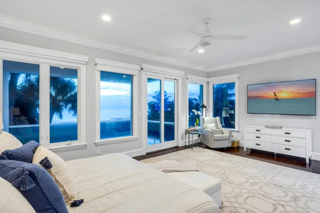 a living room with furniture wooden floor and a large window