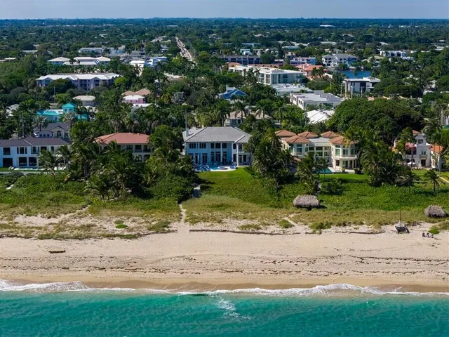 a view of a white building with large windows