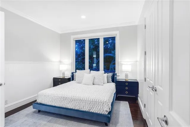 a view of a swimming pool with lawn chairs under an umbrella
