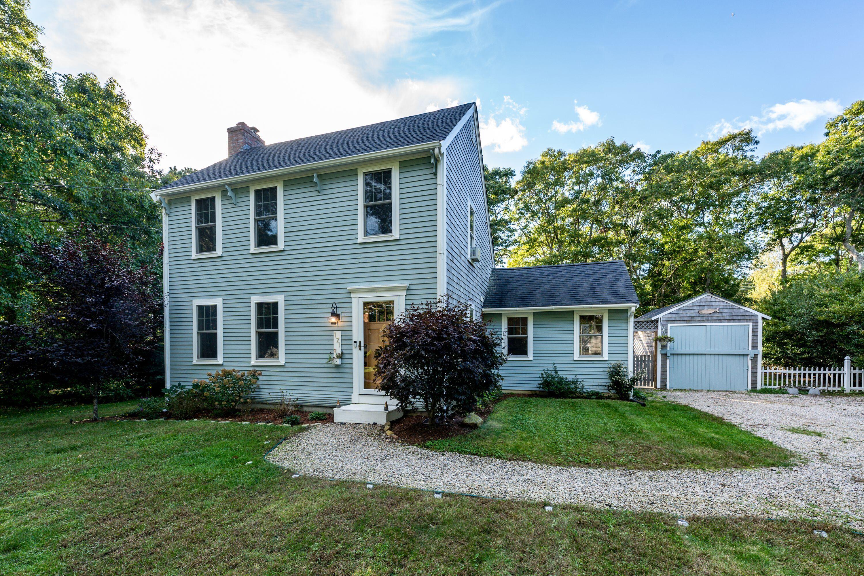 171 Cap'n Lijah's Road Centerville, MA 02632 - Photo 1 of 31 a front view of a house with a garden and yard