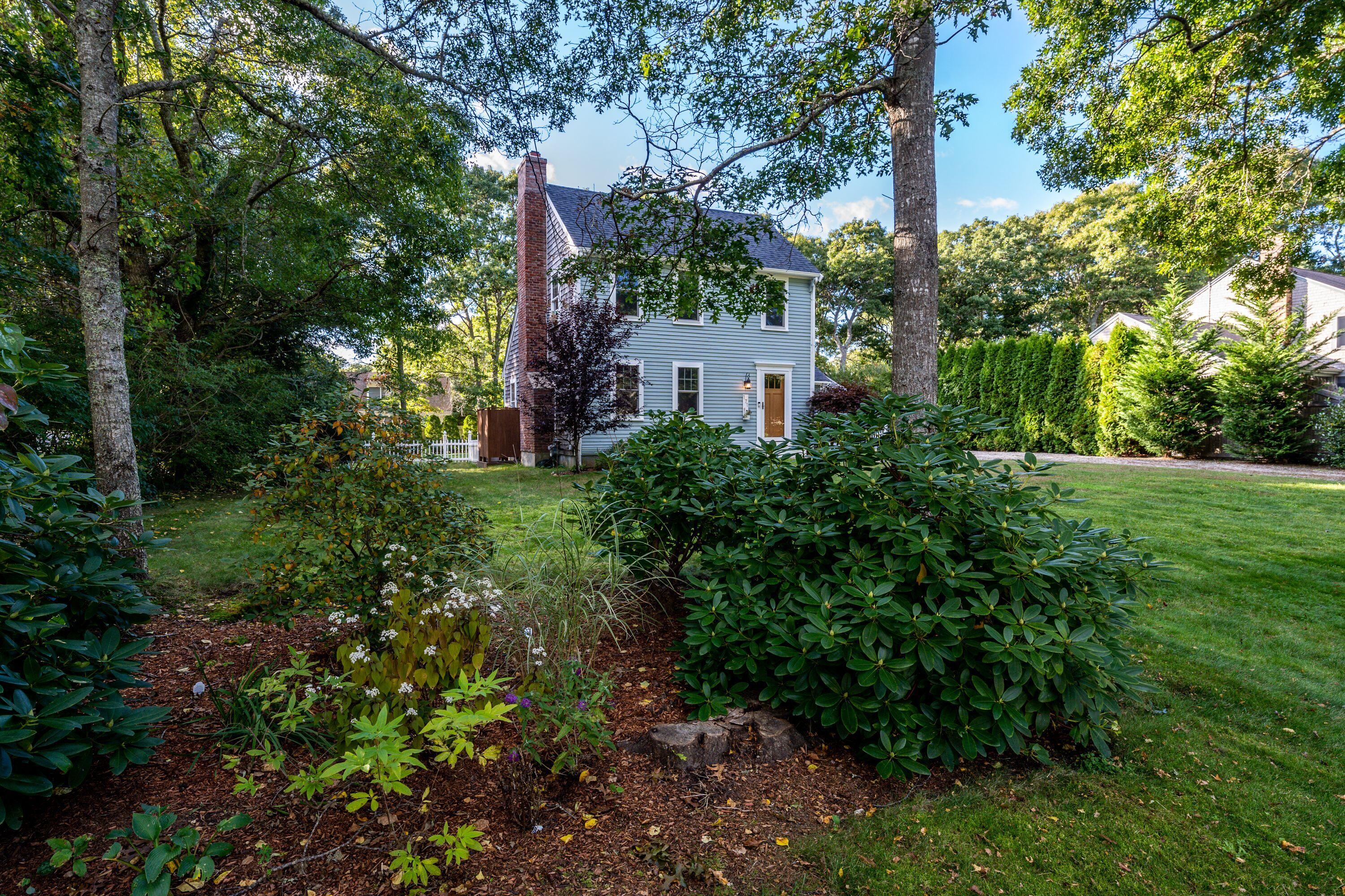 171 Cap'n Lijah's Road Centerville, MA 02632 - Photo 2 of 31 a view of a house with a yard and potted plants