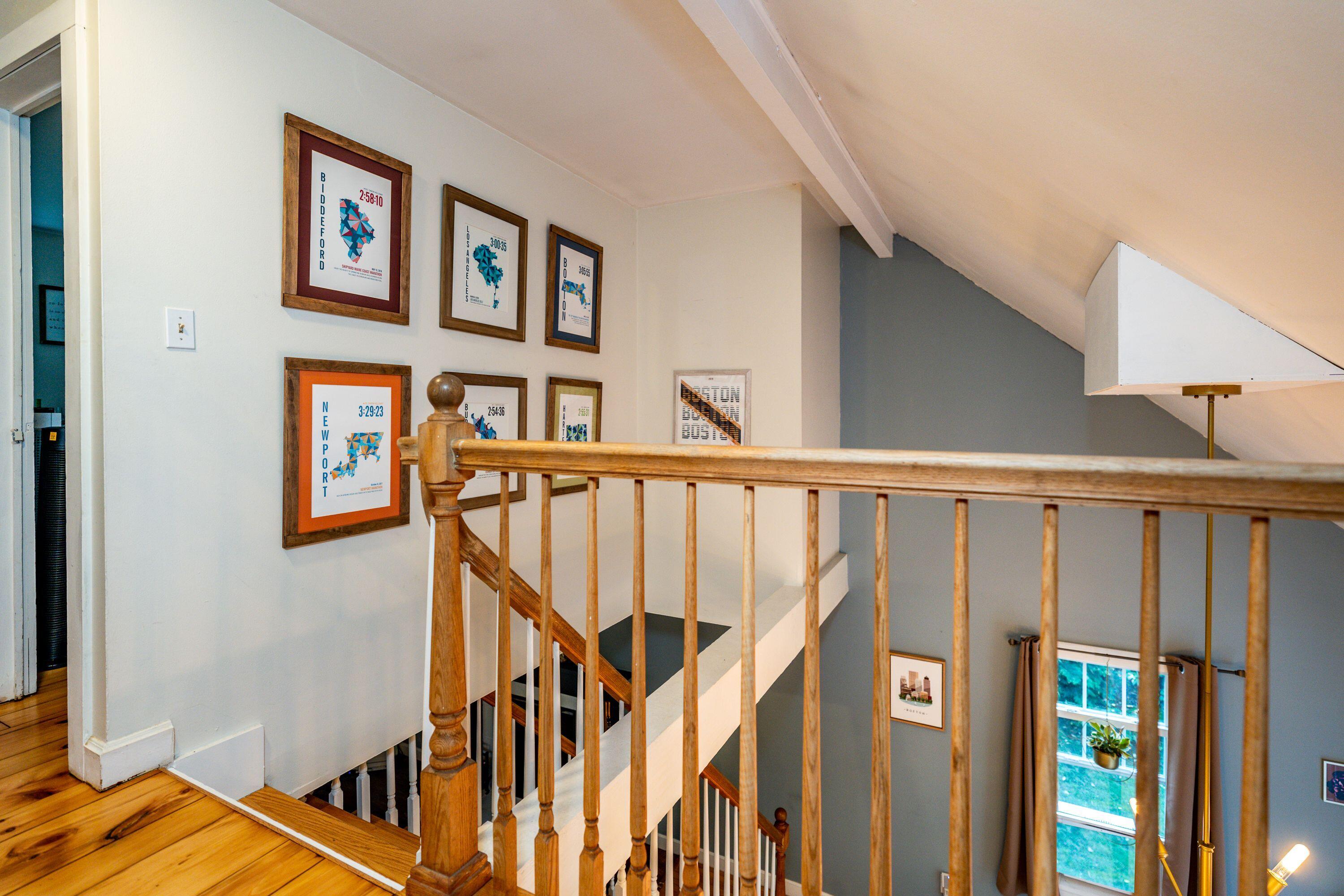 171 Cap'n Lijah's Road Centerville, MA 02632 - Photo 21 of 31 a view of staircase with lots of frames on wall and a window
