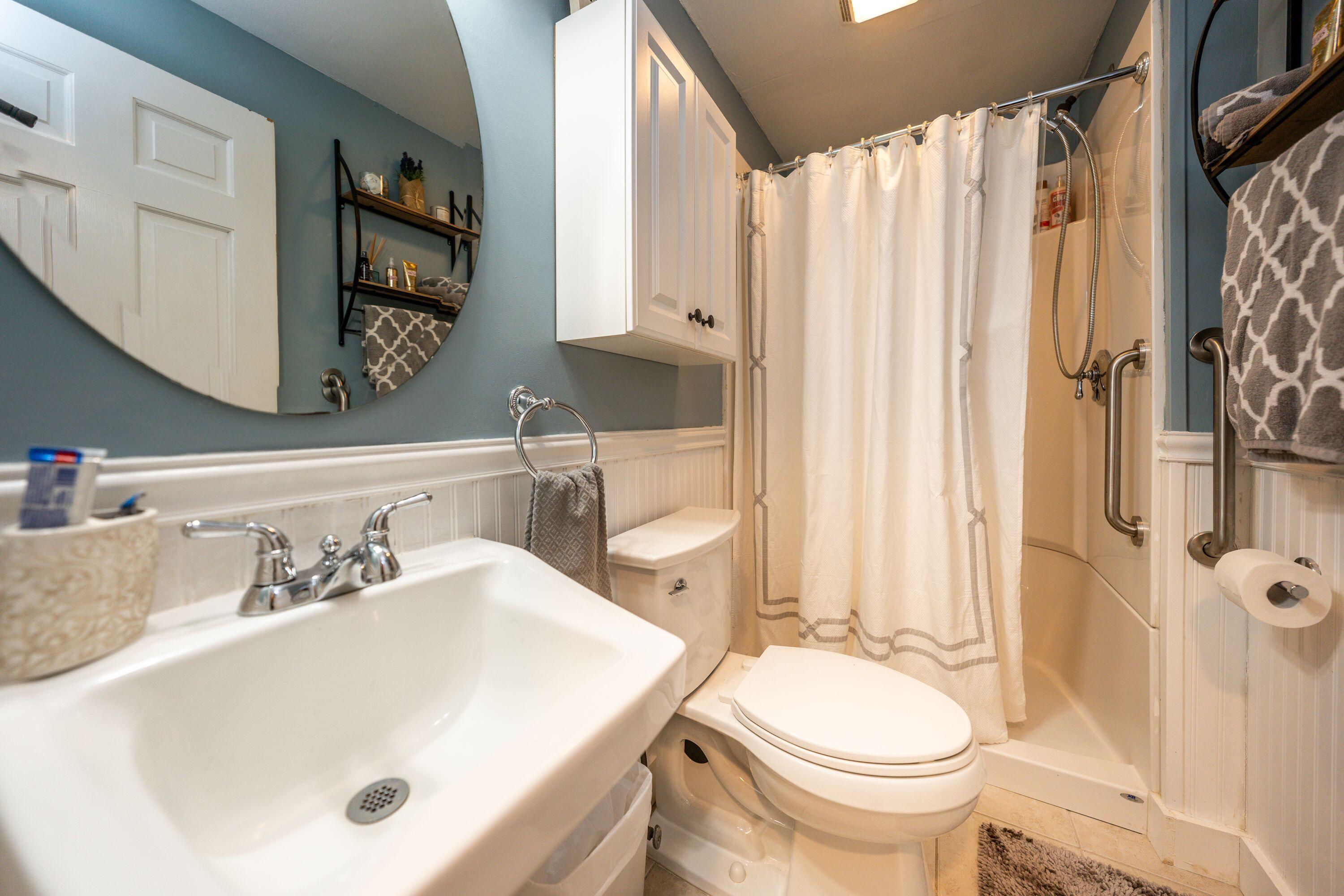 171 Cap'n Lijah's Road Centerville, MA 02632 - Photo 25 of 31 a bathroom with a sink a toilet and shower curtain