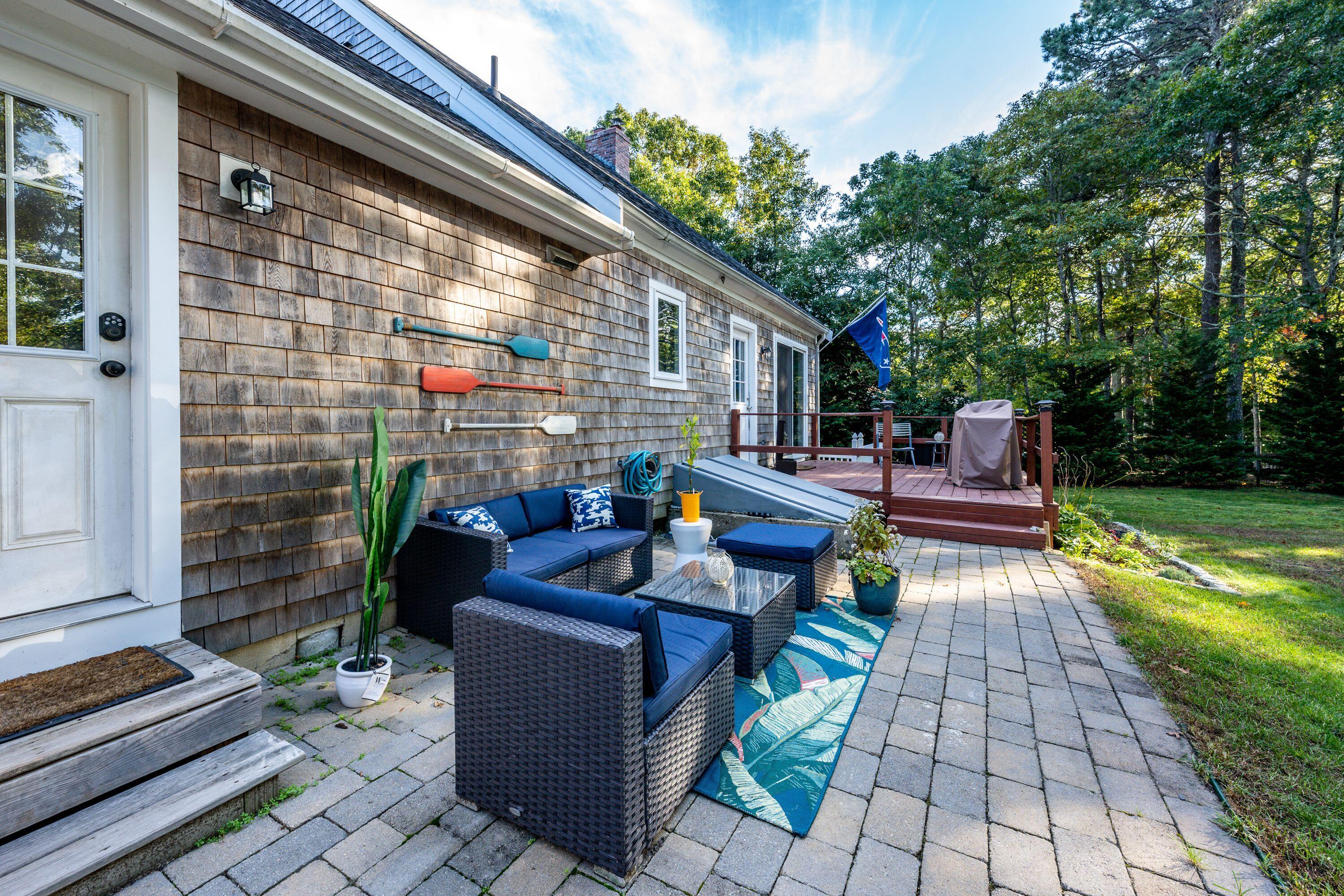171 Cap'n Lijah's Road Centerville, MA 02632 - Photo 7 of 31 a view of backyard with seating space and trees in the background