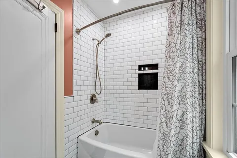 a bathroom with a shower and a bathtub