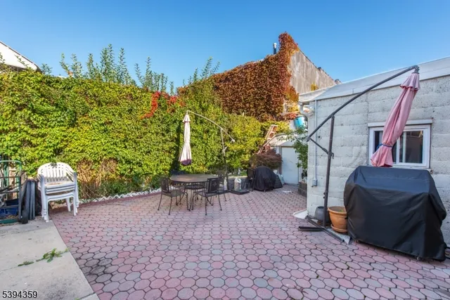 a view of a patio with a table and chairs and potted plants