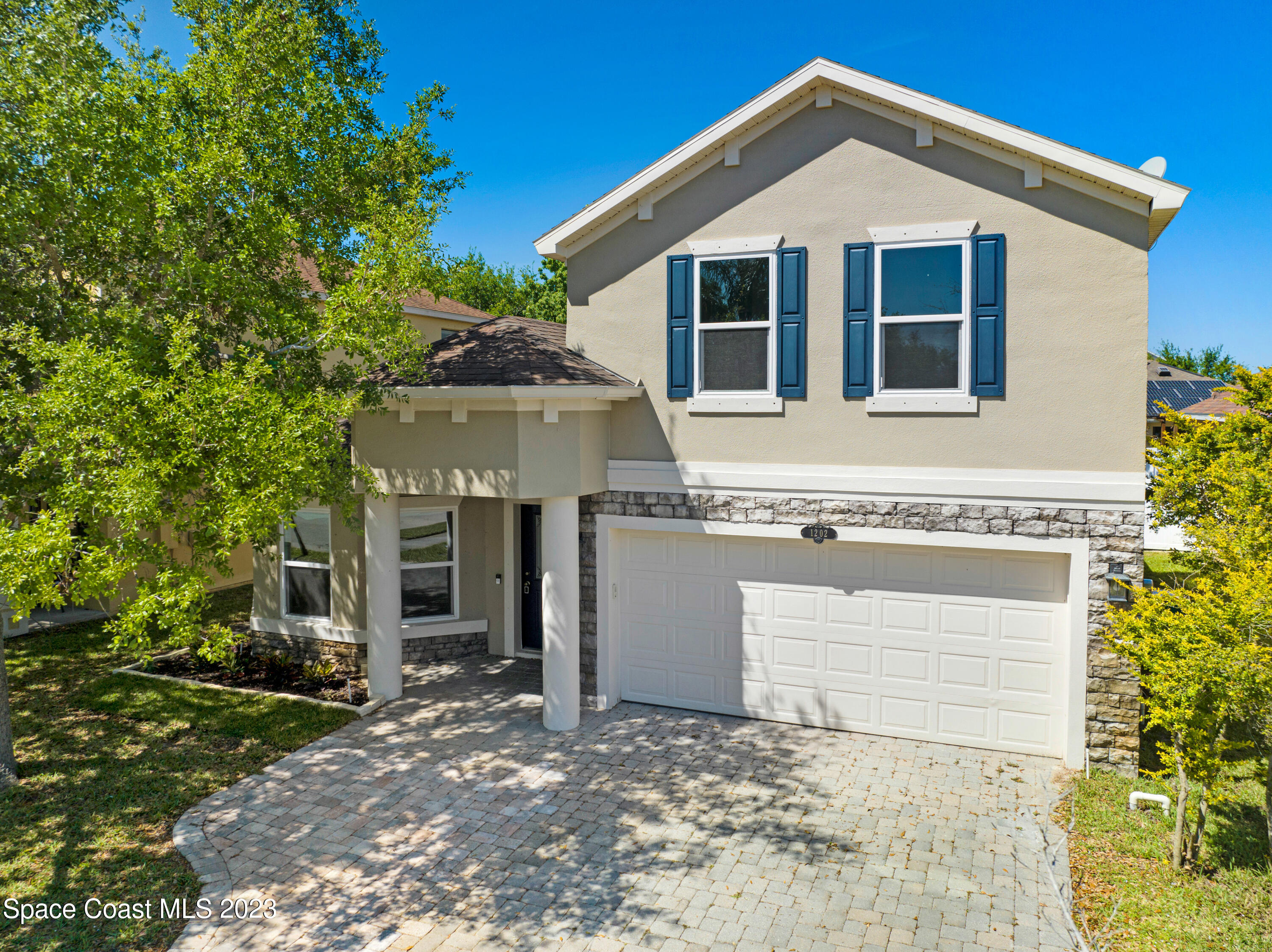 1202 Becket Place Melbourne, FL 32940 - Photo 2 of 56 a front view of a house with a yard