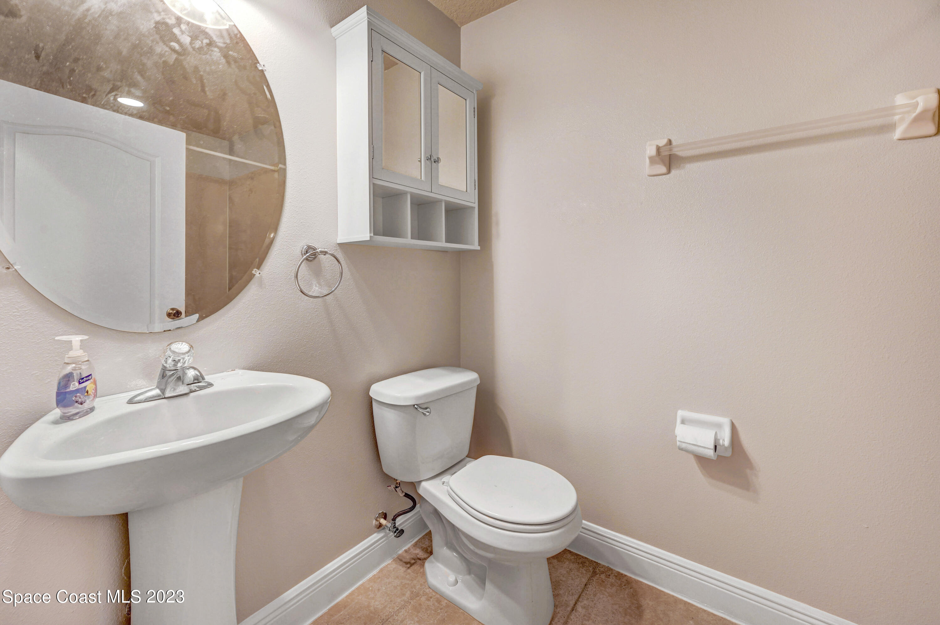 1202 Becket Place Melbourne, FL 32940 - Photo 27 of 56 a bathroom with a toilet a sink and mirror