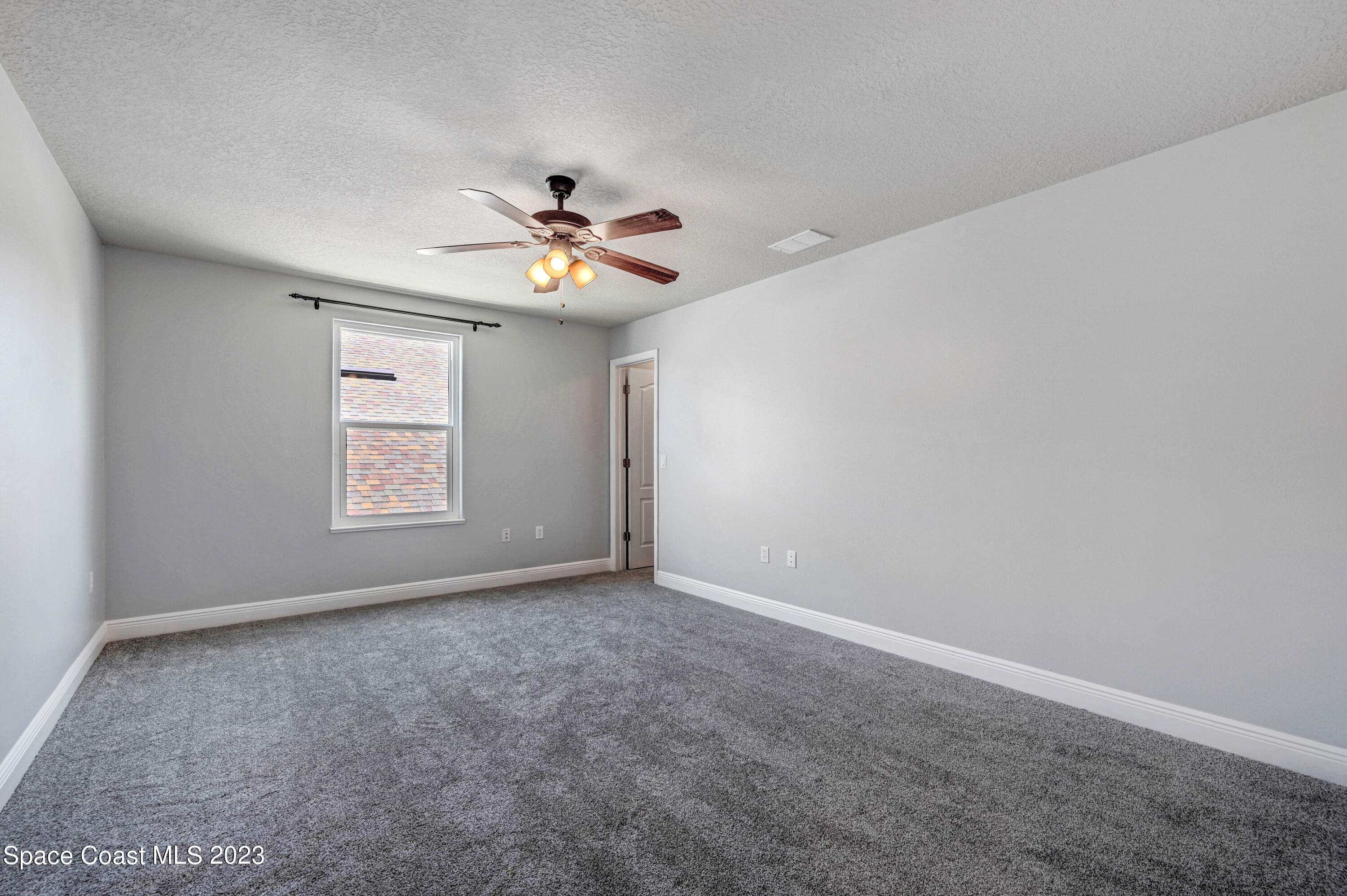 1202 Becket Place Melbourne, FL 32940 - Photo 33 of 56 an empty room with windows and fan