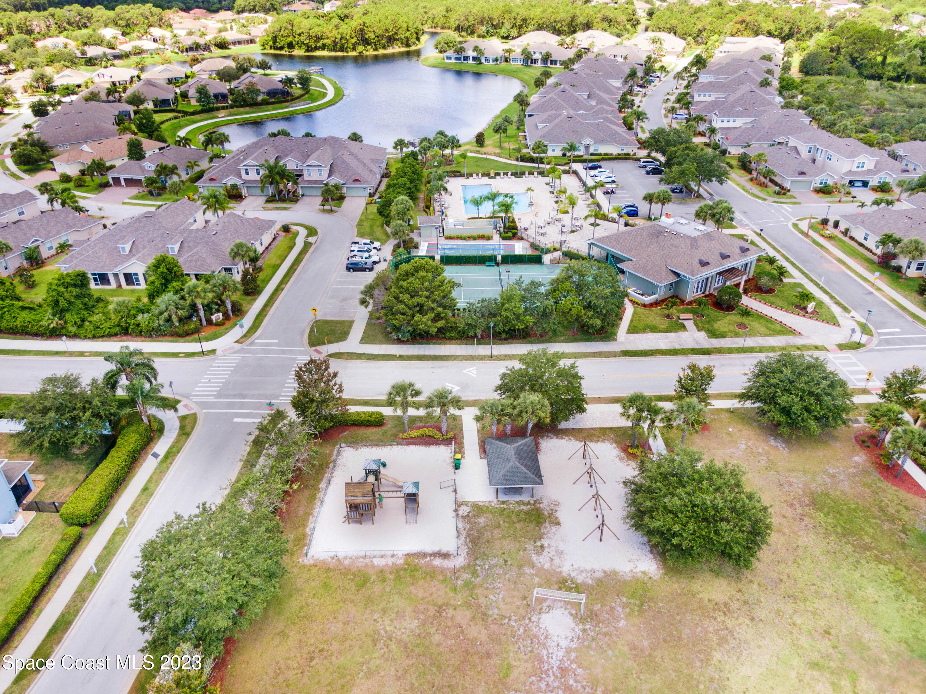 1202 Becket Place Melbourne, FL 32940 - Photo 49 of 56 an aerial view of a house with a garden and lake view