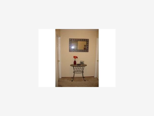 1105 Reed Avenue, Unit 0B Sunnyvale, CA 94086 - Photo 2 of 9 a living room with a chair and a potted plant