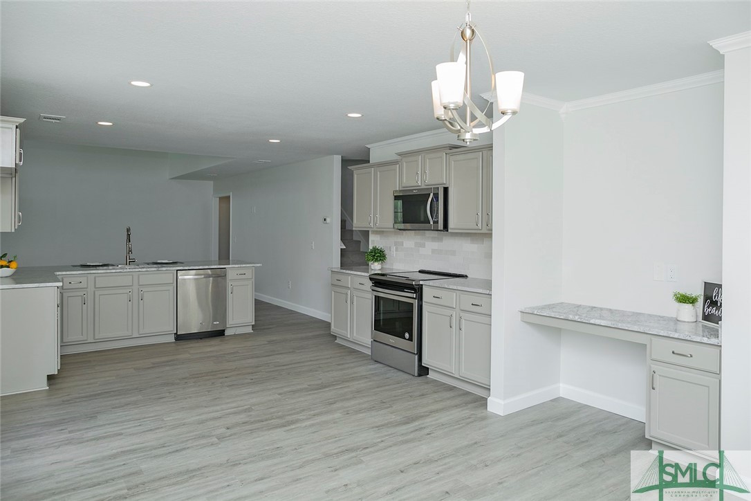 10 Fitzwater Road Port Wentworth, GA 31407 - Photo 16 of 48 Island kitchen with counter height bar featuring n