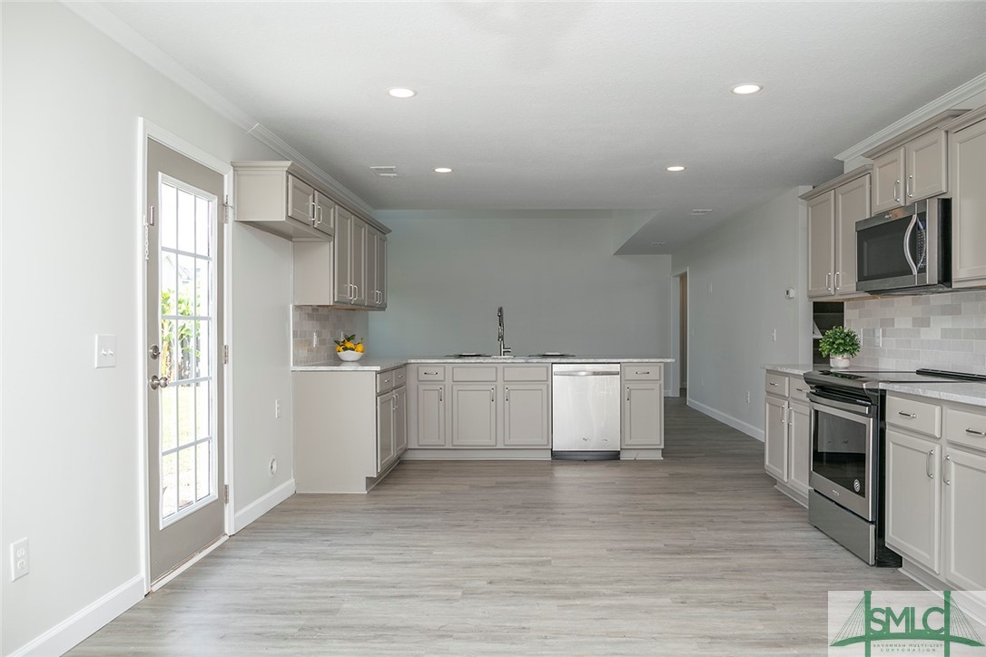 10 Fitzwater Road Port Wentworth, GA 31407 - Photo 17 of 48 Island kitchen with counter height bar featuring n