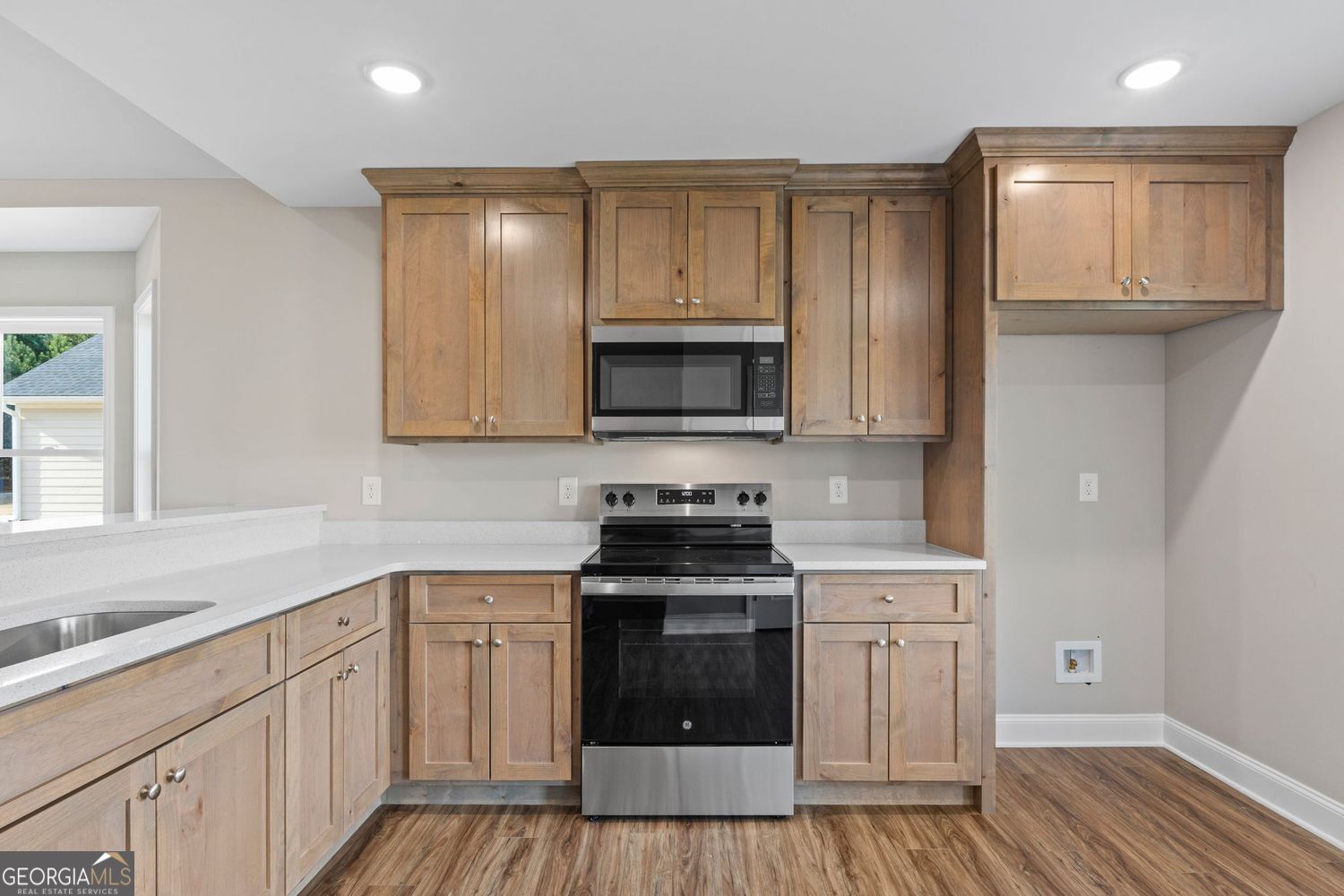 166 Mathews Road Milner, GA 30257 - Photo 11 of 32 a kitchen with a sink stove and cabinets