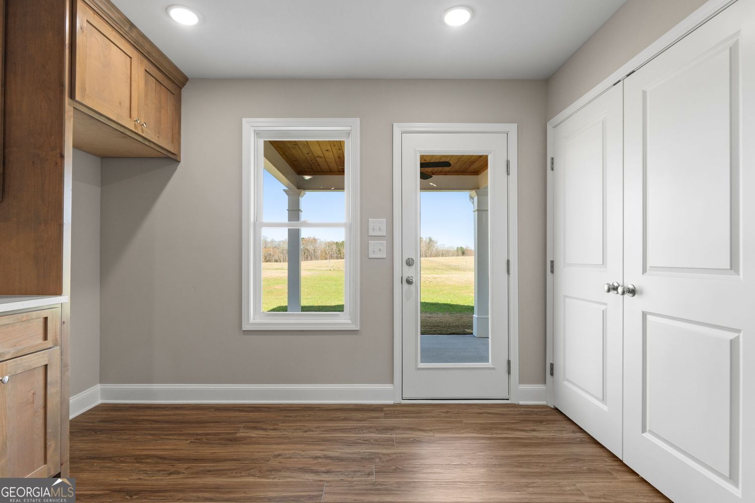 166 Mathews Road Milner, GA 30257 - Photo 15 of 32 an empty room with wooden floor and windows