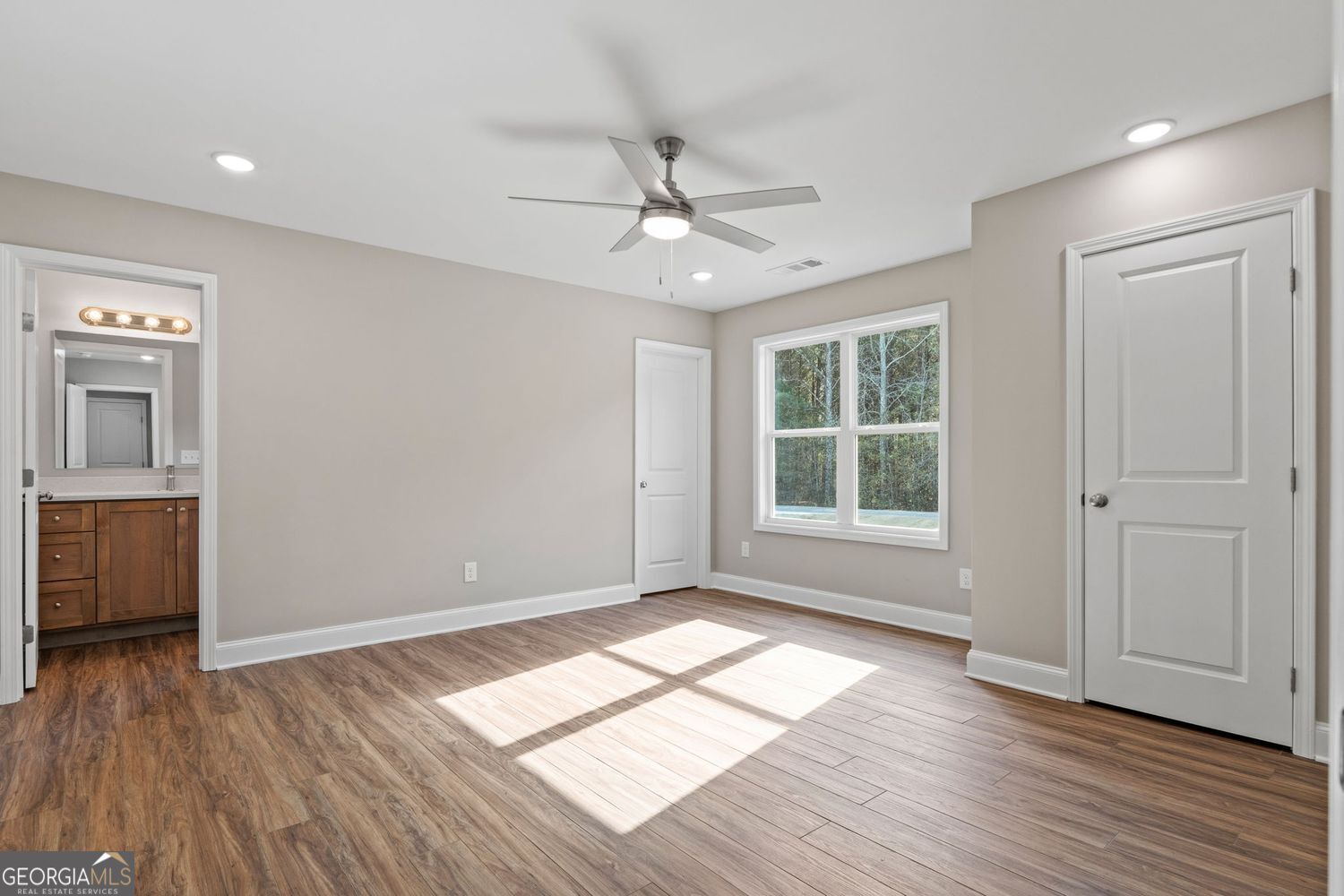 166 Mathews Road Milner, GA 30257 - Photo 16 of 32 a view of empty room with wooden floor and fan
