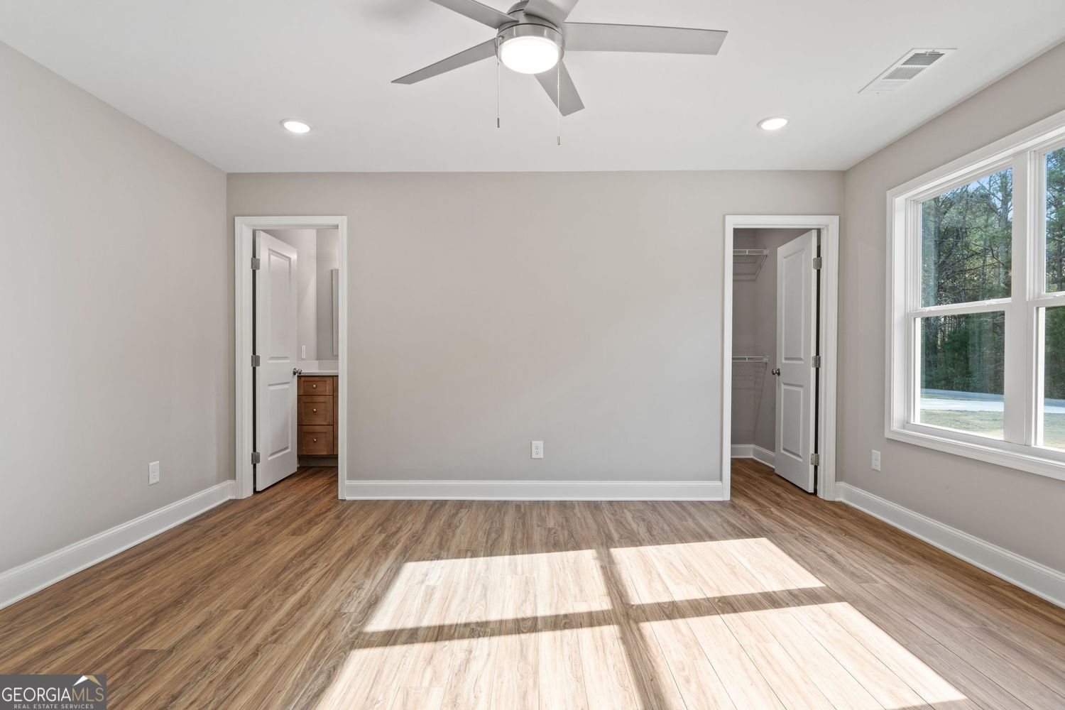 166 Mathews Road Milner, GA 30257 - Photo 18 of 32 wooden floor in an empty room with a window