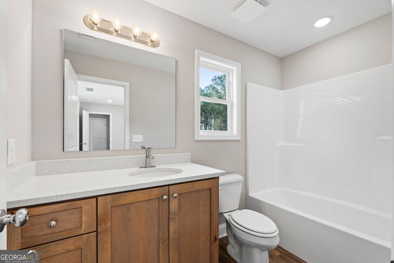 166 Mathews Road Milner, GA 30257 - Photo 19 of 32 a bathroom with a sink a toilet a mirror and shower