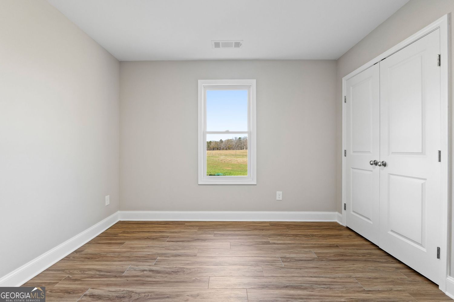 166 Mathews Road Milner, GA 30257 - Photo 23 of 32 a view of empty room with wooden floor and fan