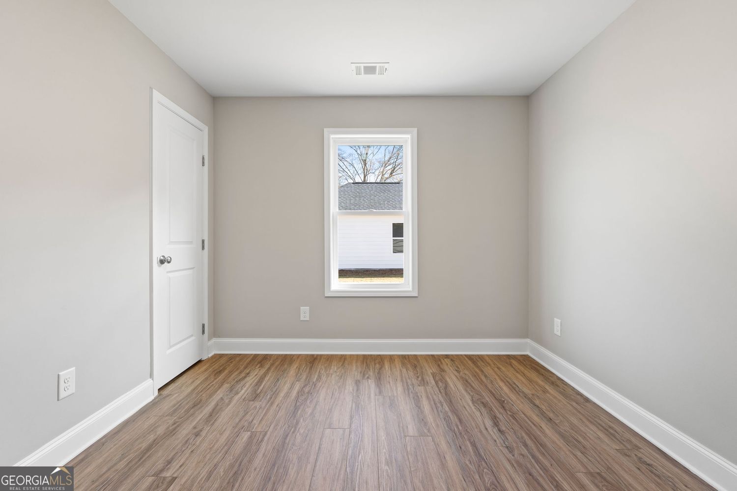 166 Mathews Road Milner, GA 30257 - Photo 24 of 32 an empty room with wooden floor and windows