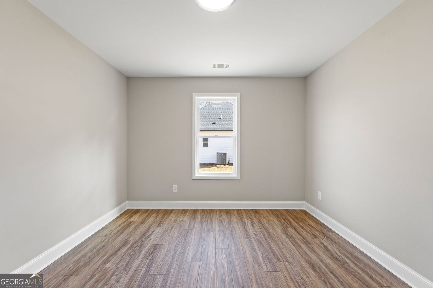 166 Mathews Road Milner, GA 30257 - Photo 27 of 32 a view of an empty room with wooden floor and a window