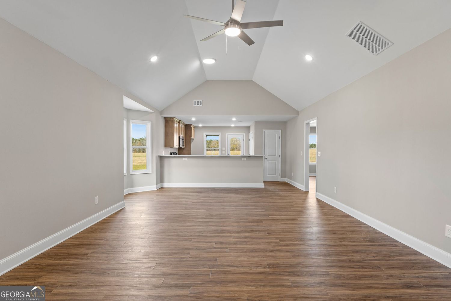166 Mathews Road Milner, GA 30257 - Photo 5 of 32 wooden floor in an empty room with a window