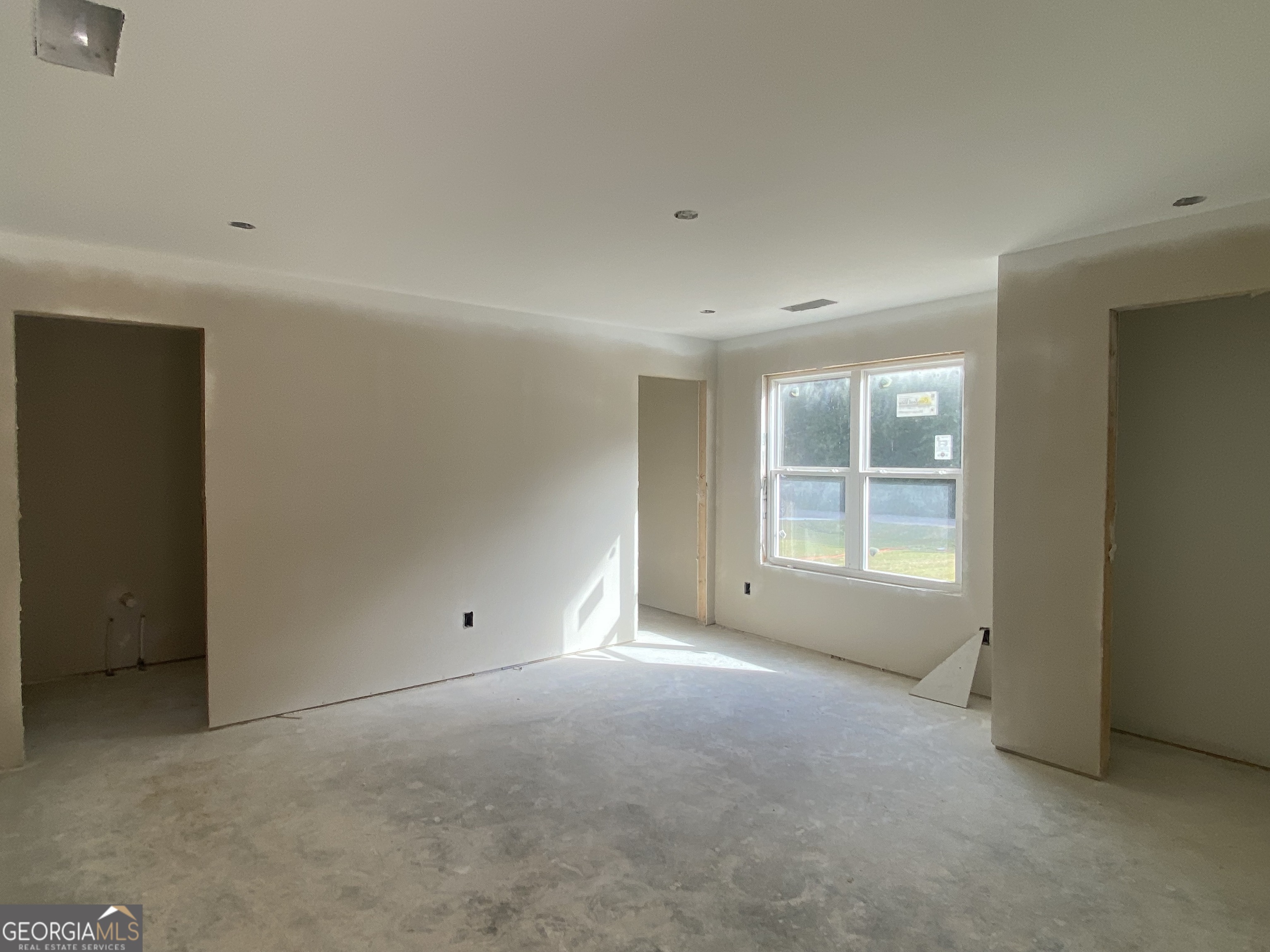 166 Mathews Road Milner, GA 30257 - Photo 7 of 14 an empty room with a empty space and windows