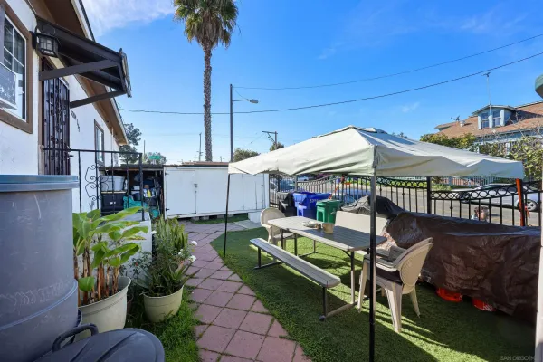 a view of a patio with table and chairs potted plants