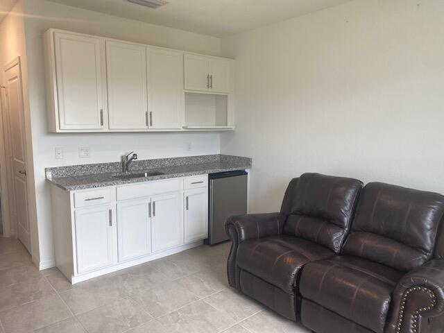 5133 Armina Place, Unit STUDIO Fort Pierce, FL 34951 - Photo 1 of 18 a living room with furniture a sink and cabinets