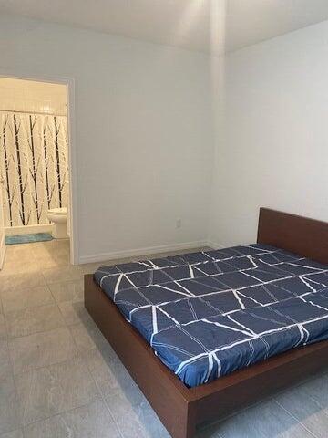 5133 Armina Place, Unit STUDIO Fort Pierce, FL 34951 - Photo 14 of 18 a bed sitting in a bedroom next to a window