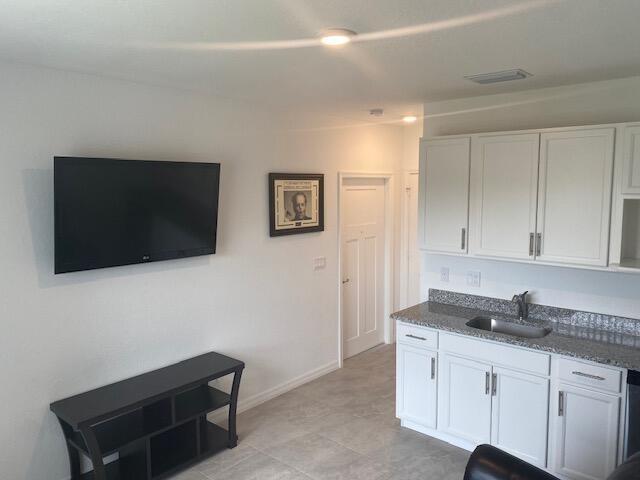 5133 Armina Place, Unit STUDIO Fort Pierce, FL 34951 - Photo 2 of 18 a living room with furniture and a flat screen tv