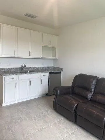 a living room with a couch and cabinets
