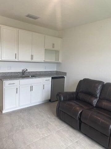 5133 Armina Place, Unit STUDIO Fort Pierce, FL 34951 - Photo 4 of 18 a living room with a couch and cabinets