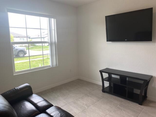 5133 Armina Place, Unit STUDIO Fort Pierce, FL 34951 - Photo 5 of 18 a view of workspace with furniture and flat screen tv